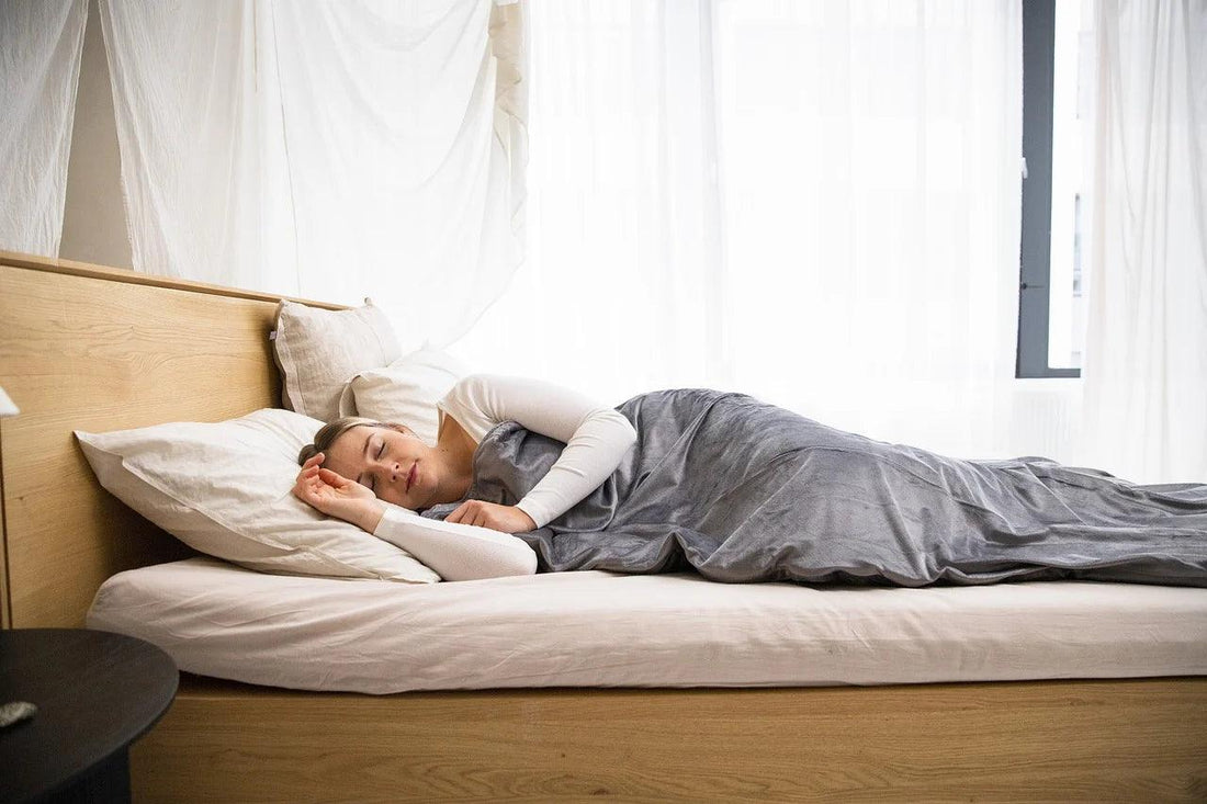 A woman lying on a bed peacefully.