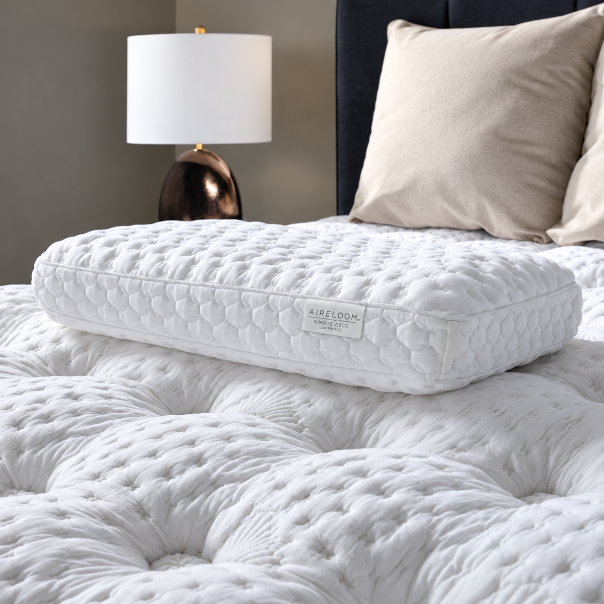 Aireloom Nimbus Visco Foam Pillow with open-cell foam and a removable TENCEL™ cover sitting on a mattress.