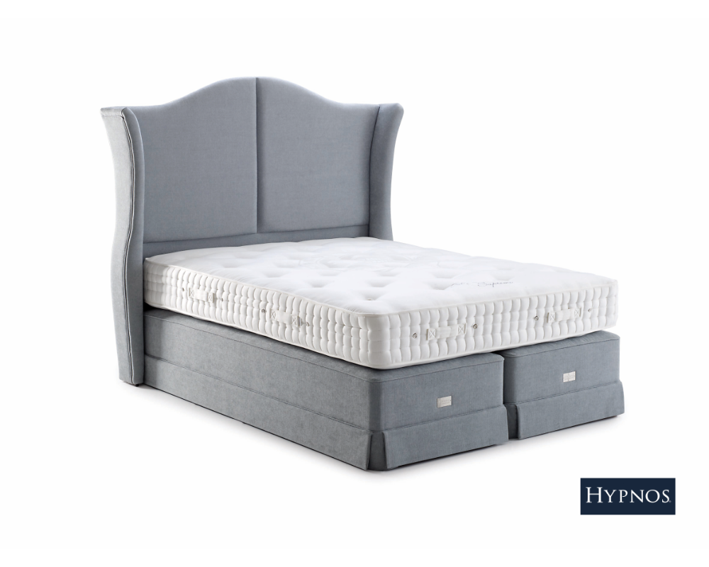 Gray upholstered bed with Hypnos Carlisle mattress on a white background.