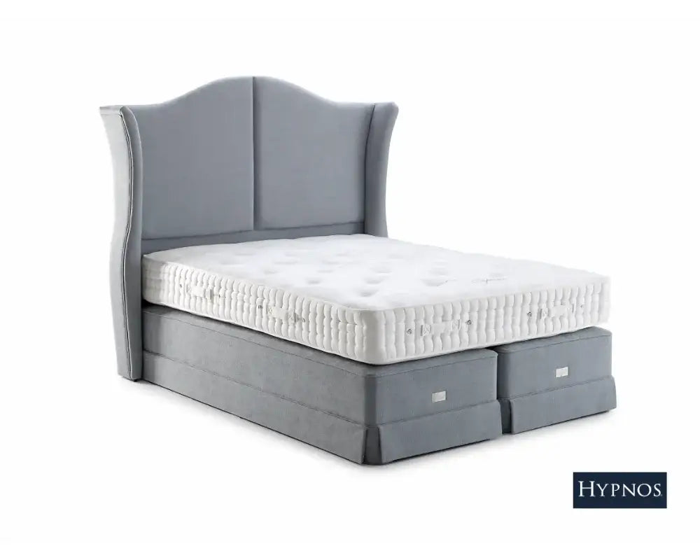 Gray upholstered bed with Hypnos Carlisle mattress on a white background.