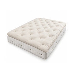 A tufted Alpaca mattress topper on Hypnos Carlisle mattress shown at an angle on a clean white background. The top surface features a diamond tufted pattern in a warm cream color.