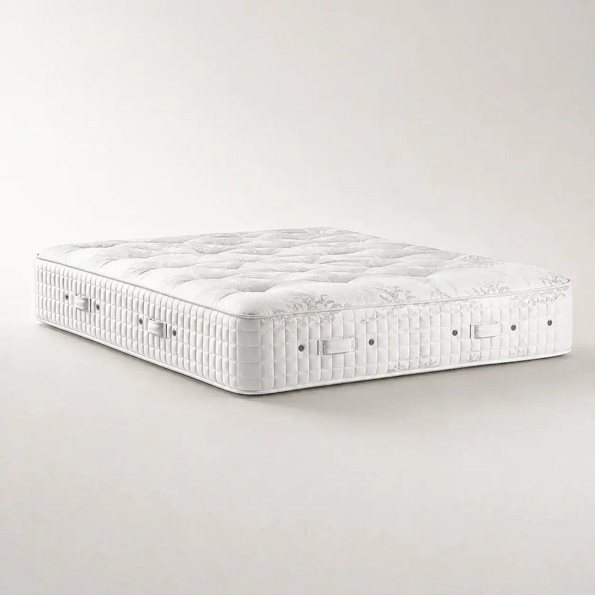 Hypnos Viceroy Sovereign two sided tufted premium mattress shown at an angle on a clean, light beige studio background.