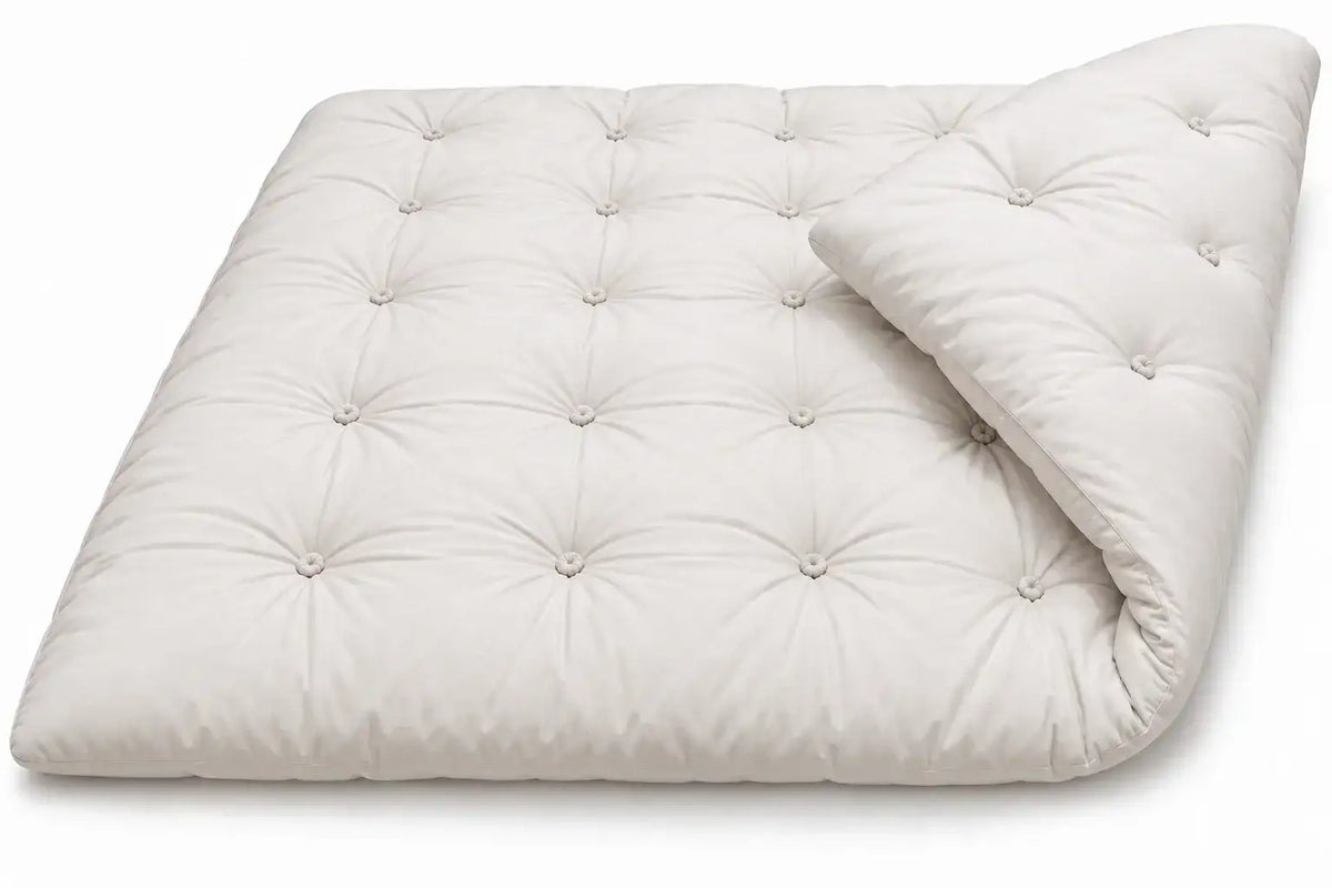 Flippable Sprout Alpaca Wool Tufted Mattress Topper showing its plush corner folded.